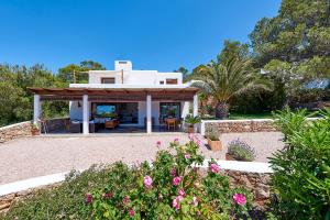 a villa with a view of the garden at Villa Sa Codolar in Cala Tarida