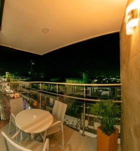 a room with a table and chairs on a balcony at HOTEL SAN PEDRO PITALITO in Pitalito