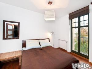 Posteľ alebo postele v izbe v ubytovaní Apartament Haffnera 10