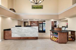 a lobby of a store with a marble counter at Baymont by Wyndham Augusta West in Augusta