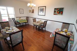 a dining room with a table and chairs and a table and chairsktop at The Fiddle and the Sea Bed and Breakfast in Port Hood
