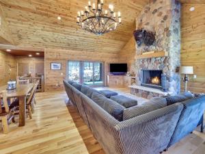 a living room with a couch and a fireplace at Wee-Kin-Da-Wa in Boyne Falls