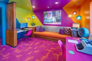 a colorful room with a couch and a desk at Accent Inns Vancouver Airport in Richmond
