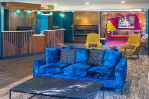 a living room with a blue couch and chairs at Accent Inns Vancouver Airport in Richmond