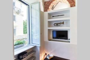 Televízia a/alebo spoločenská miestnosť v ubytovaní JaZZino