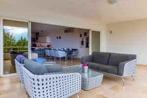 a living room with two couches and a table at Seaside Queen Suite in Kralendijk