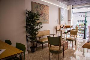 a restaurant with a row of chairs and tables at Acolá Rooms in Pontevedra