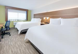 a hotel room with two beds and a desk at Holiday Inn Express & Suites San Antonio NW near SeaWorld, an IHG Hotel in San Antonio