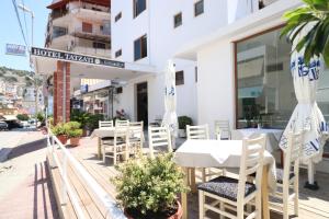 a restaurant with a table and chairs on the street at Hotel Tatzati 2 in Sarandë