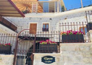 a building with potted flowers on the stairs at Vigneron Cave Hotel in Nevsehir