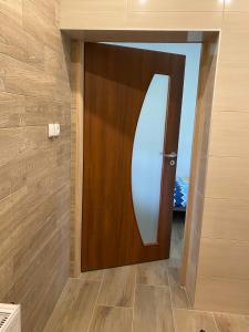a wooden door in a room with a wall at Apartamenty Ustroń in Ustroń +15 photos