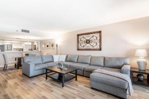 a living room with a couch and a table at Reflections Gulf Front Condo With Ocean Views in Clearwater Beach
