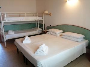 two beds in a room with two bunk beds at Villa Dei Romanzi in Tortoreto Lido