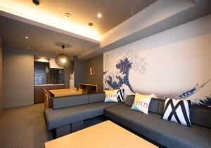 a living room with a couch and a table at Minn Ueno in Tokyo