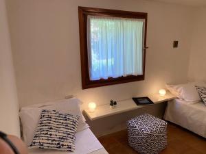 a room with two beds and a window with lights at Domus Olivarum - Costa Smeralda 6 guest, 3 room, 2 bathroom, 2 parking Wifi in Abbiadori