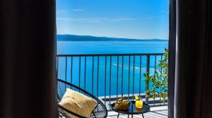 a balcony with a table and a view of the water at Villa The View in Omiš