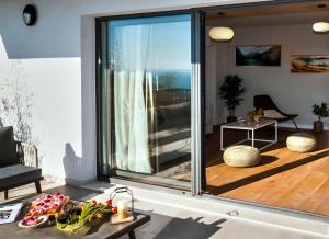 a living room with a large sliding glass door at Villa The View in Omiš