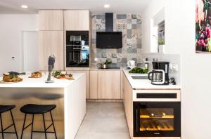 a kitchen with a stove and a counter with stools at Villa The View in Omiš +68 photos