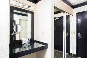 
a bathroom with a sink and a mirror at OYO Hotel and Casino Las Vegas in Las Vegas
