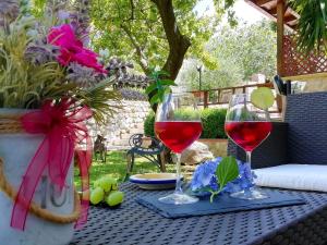 two glasses of red wine sitting on a table at B&B Maison Villa Vittorio in Avella