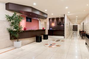 a lobby of a hotel with a potted plant at the b hakata in Fukuoka