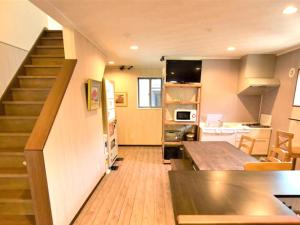 a kitchen with a staircase leading up to a living room at Field Hakone Resort in Hakone