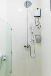 a shower in a white bathroom with a shower at Aownoi Bay Resort in Prachuap Khiri Khan