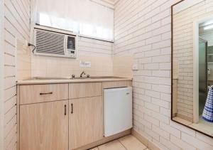 a bathroom with a sink and a mirror at Burwood East Motel in Burwood