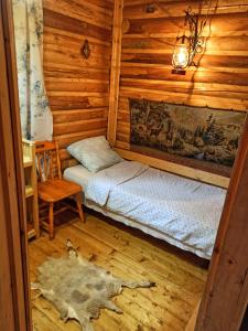 a room with two beds in a log cabin at Еко Садиба Під Полониною in Sasivka