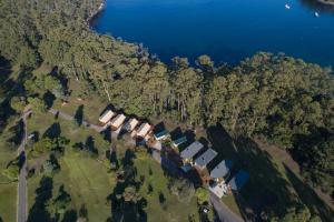 an aerial view of a group of houses next to the water at NRMA Port Arthur Holiday Park in Port Arthur