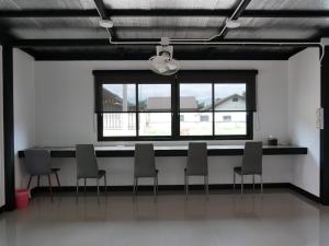 a room with chairs and a table and a window at Fang Villa Hotel in Fang