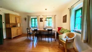 a living room with a dining room table and chairs at STEYR RIVER LODGE in Hinterstoder