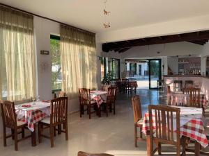 a restaurant with tables and chairs with red and white tablecloths at Family Studios in Marathias