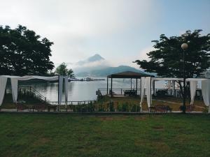 a group of tables and chairs next to a body of water at Interlaken Stay in Gapyeong
