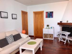 a living room with a couch and a table at Atiko 15 in Gijón