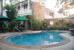 a patio area with a pool and a lawn chair at Place D'Armes Hotel in New Orleans