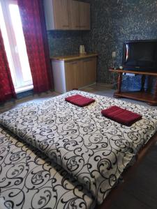 a bedroom with a bed with two red pillows on it at Гостевая комната in Kyiv