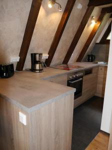 a kitchen with a counter top and a stove at Ferienhaus im Nordschwarzwald Haus Kira in Schellbronn