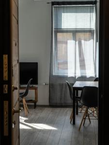 a room with a table and chairs and a window at SUNBEAM DESIGN APARTMENT in Rīga