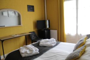 A bed or beds in a room at Hotel de L'Europe, La Roche-Posay