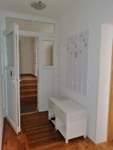 a white room with a white bench in it at Apartments & Rooms 4 Rijeke in Karlovac