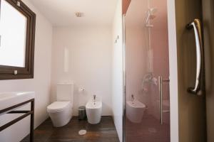 a bathroom with a shower and a toilet and a sink at La Albacara in Moya