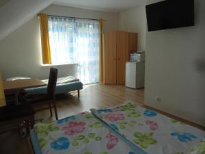 a room with a bed and a table and a kitchen at Ośrodek Korab in Władysławowo +27 photos