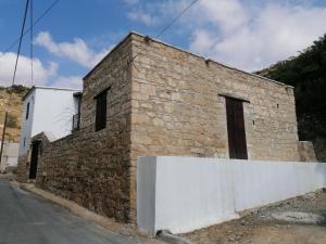 a brick building on the side of a street at CASAVERO in Oroklini