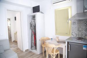 a kitchen and dining room with a table and chairs at Diasino Apartments and Car Rental in Katapola
