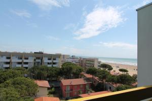 a view of the beach from the balcony of a building at FLATS SOLARIUM in Bibione