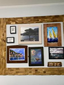 a wall with a bunch of pictures on it at Apartments Vila Vino in Sveta Nedelja
