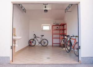two bikes are parked in a room with a bathroom at Lavanda Apartment in Fažana