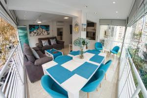 - une salle à manger et un salon avec une table et des chaises dans l'établissement My Sweet Blue Apartment, à Benidorm