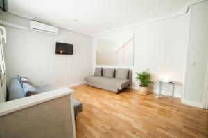a living room with a couch and a table at Apartments Madrid Principe in Madrid